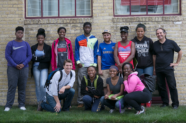 Teens and tour director pose for a group photo at tour's end.
